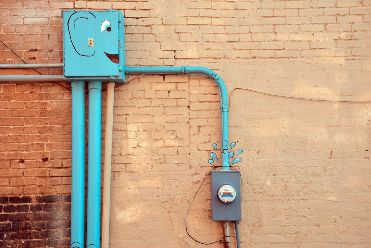 Mastering the First Impression: Your intriguing post title goes here A quirky outdoor scene featuring painted utility meters and piping on a brick wall in Texarkana, Texas.